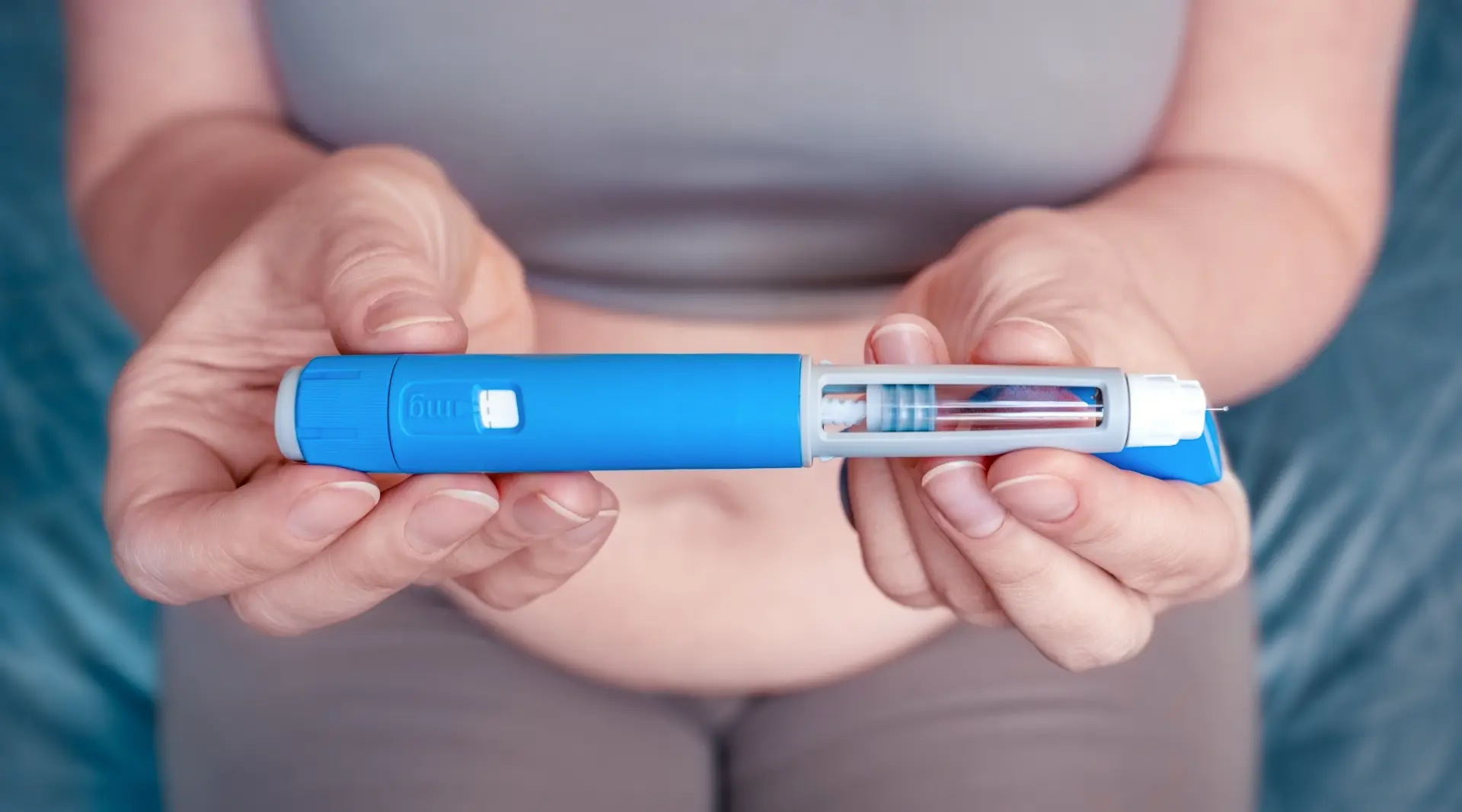Patient holding a GLP-1 injection pen